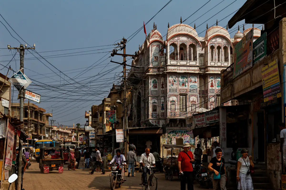 Busy street in Fatehpur, Shekhawati, with a painted temple facade
