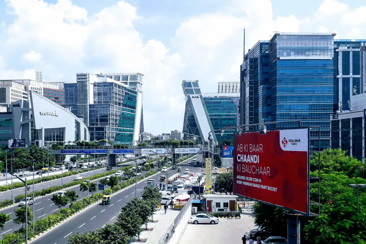 Glass office towers of DLF Cyber City in Gurugram along the expressway