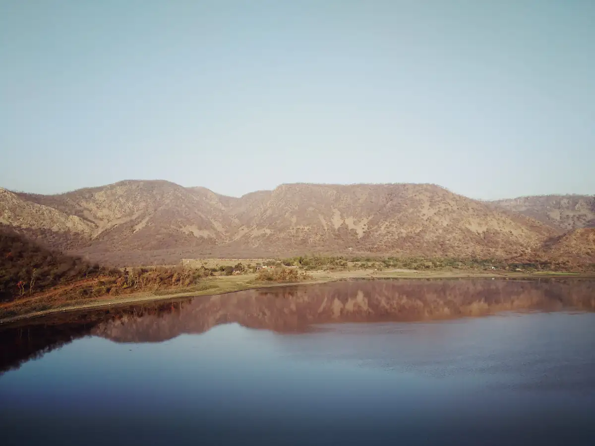 Still waters of Siliserh Lake reflecting the bare Aravalli hills near Alwar