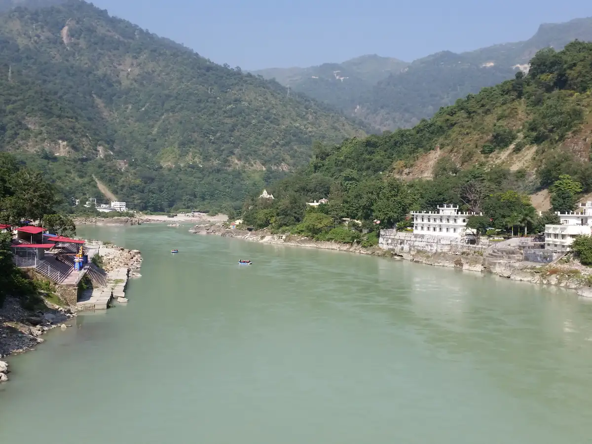 The Ganga flowing between forested hills at Rishikesh