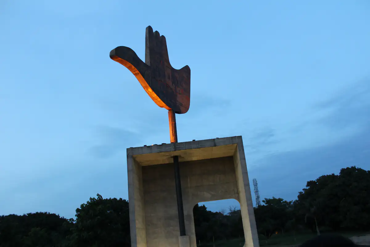 The Open Hand Monument at Chandigarh's Capitol Complex against a blue sky