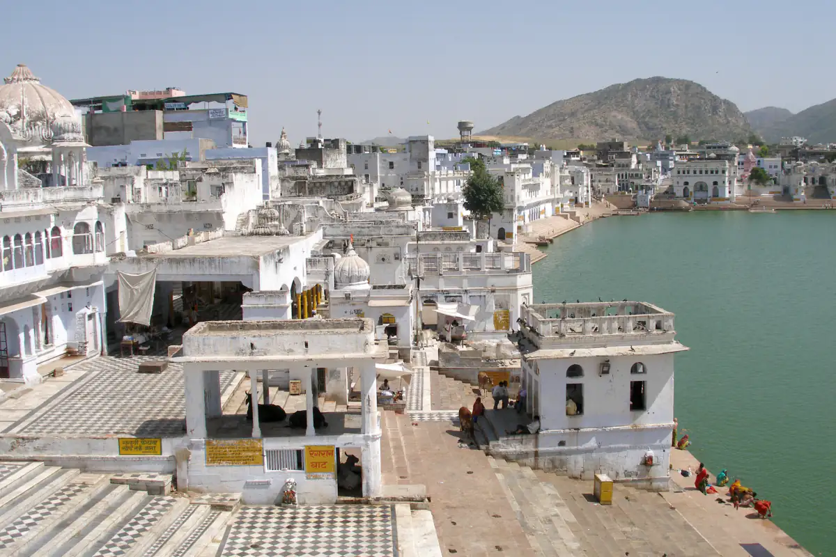 White ghats and temples along Pushkar Lake with the Aravalli hills behind